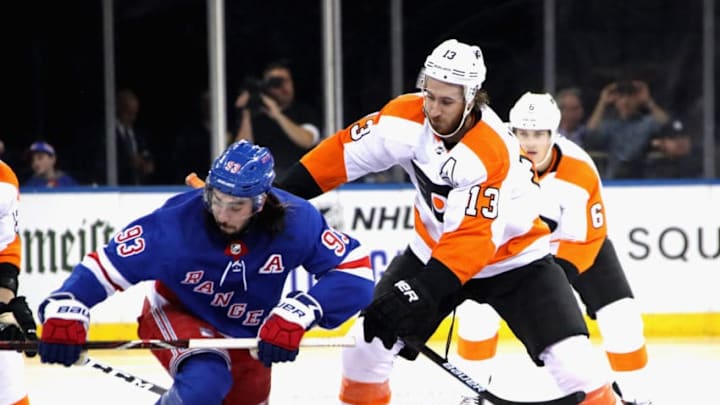 NEW YORK, NEW YORK - SEPTEMBER 26: Kevin Hayes #13 of the Philadelphia Flyers takes the faceoff against Mika Zibanejad #93 of the New York Rangers during the third period during a preseason game at Madison Square Garden on September 26, 2019 in New York City. The Rangers defeated the Flyers 2-1 in the shoot-out. (Photo by Bruce Bennett/Getty Images)