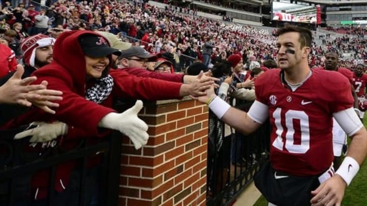 Nov 23, 2013; Tuscaloosa, AL, USA; Alabama Crimson Tide quarterback A.J. McCarron (10) celebrates by making a victory lap around the stadium after their 49-0 win over the Chattanooga Mocs at Bryant-Denny Stadium. This was McCarron