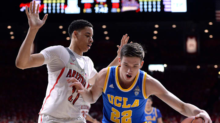 Feb 25, 2017; Tucson, AZ, USA; UCLA Bruins forward TJ Leaf (22) dribbles the ball as Arizona Wildcats center Chance Comanche (21) defends during the first half at McKale Center. Mandatory Credit: Casey Sapio-USA TODAY Sports