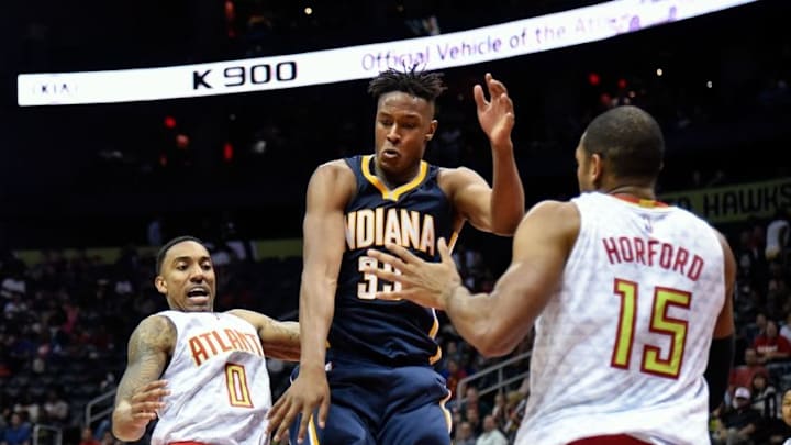 Mar 13, 2016; Atlanta, GA, USA; Indiana Pacers forward Myles Turner (33) fights for the ball with Atlanta Hawks center Al Horford (15) and guard Jeff Teague (0) during the second half at Philips Arena. The Hawks defeated the Pacers 104-75. Mandatory Credit: Dale Zanine-USA TODAY Sports