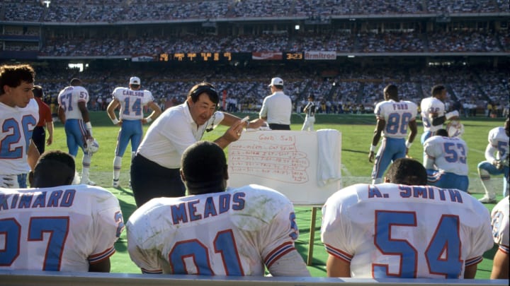 ANAHEIM, CA – NOVEMBER 4: (L-R) Safety Bo Orlando #26, safety Terry Kinard #27, linebacker Johnny Meads #91 and linebacker Al Smith #54 of the Houston Oilers listen to defensive coordinator Jim Eddy during the game against the Los Angeles Rams at Anaheim Stadium on November 8, 1990 in Anaheim, California. The Rams won 17-13. (Photo by George Rose/Getty Images)