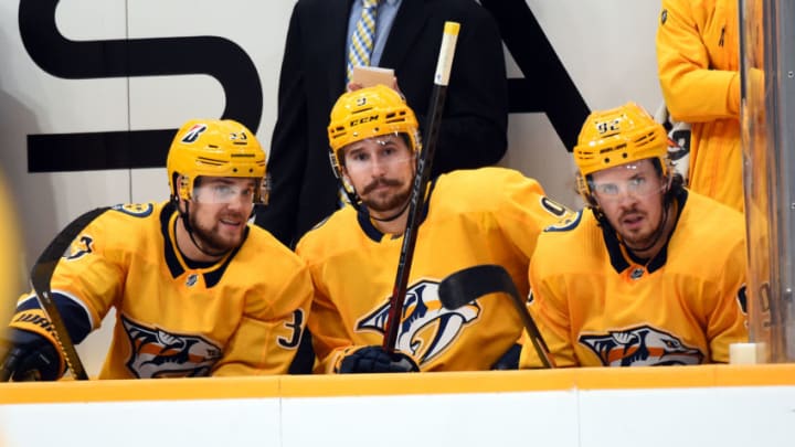 Jan 14, 2021; Nashville, Tennessee, USA; Nashville Predators right wing Viktor Arvidsson (33) Nashville Predators left wing Filip Forsberg (9) and Nashville Predators center Ryan Johansen (92) look on from the bench during the first period against the Columbus Blue Jackets at Bridgestone Arena. Mandatory Credit: Christopher Hanewinckel-USA TODAY Sports