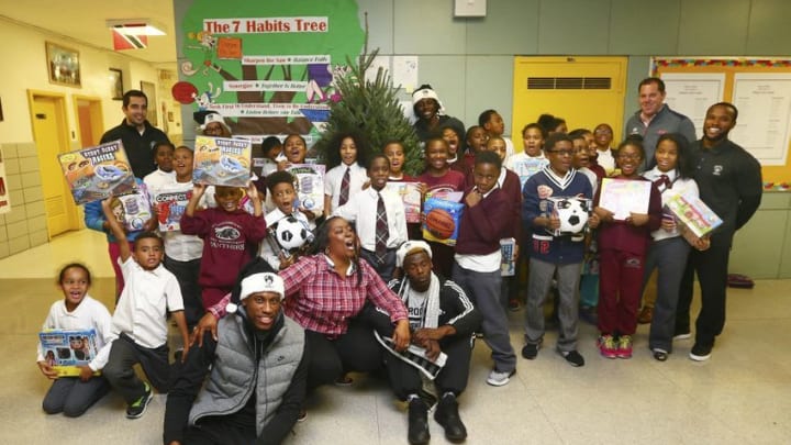 Dec 3, 2015; Brooklyn , NY, USA; Brooklyn Nets star Thaddeus Young poses for a photo with students from P.S. 21 during the Thaddeus Young Christmas gift giveaway in Brooklyn, New York. Mandatory Credit: Andy Marlin-USA TODAY Sports