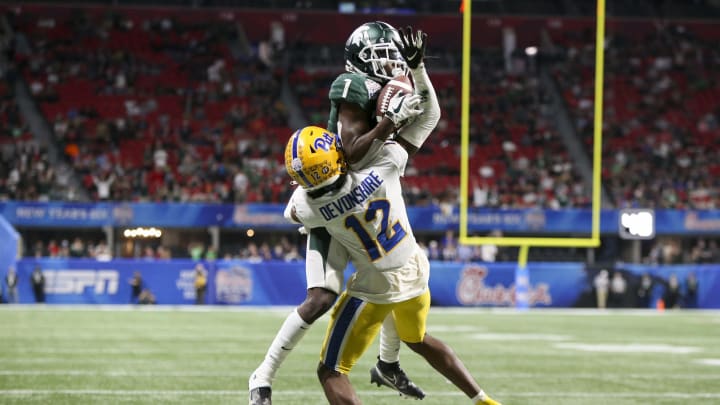 Dec 30, 2021; Atlanta, GA, USA; Michigan State Spartans wide receiver Jayden Reed (1) catches a touchdown pass over Pittsburgh Panthers defensive back M.J. Devonshire (12) in the second half during the 2021 Peach Bowl at Mercedes-Benz Stadium. Mandatory Credit: Brett Davis-USA TODAY Sports