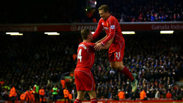 LIVERPOOL, ENGLAND - DECEMBER 29: Jordan Henderson of Liverpool celebrates with team-mate Lucas Leiva after Jonjo Shelvey of Swansea City scored an own goal during the Barclays Premier League match between Liverpool and Swansea City at Anfield on December 29, 2014 in Liverpool, England. (Photo by Clive Brunskill/Getty Images)