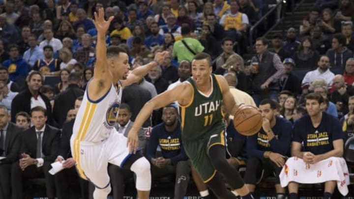 December 20, 2016; Oakland, CA, USA; Utah Jazz guard Dante Exum (11) dribbles the basketball against Golden State Warriors guard Stephen Curry (30) during the third quarter at Oracle Arena. The Warriors defeated the Jazz 104-74. Mandatory Credit: Kyle Terada-USA TODAY Sports