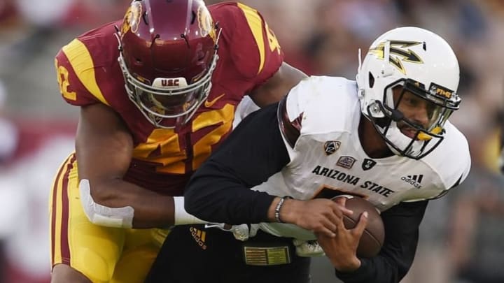 Oct 1, 2016; Los Angeles, CA, USA; Arizona State Sun Devils quarterback Manny Wilkins (right) runs the ball tackled by Southern California Trojans linebacker Uchenna Nwosu (left) during the first half at Los Angeles Memorial Coliseum. Mandatory Credit: Kelvin Kuo-USA TODAY Sports