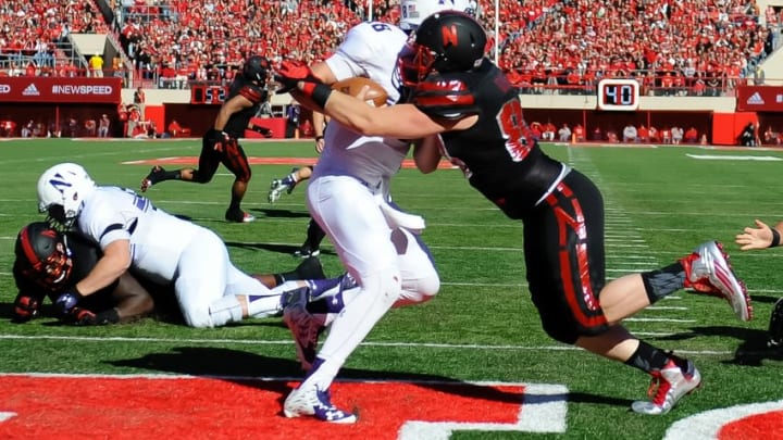 Oct 24, 2015; Lincoln, NE, USA; Northwestern Wildcats quarterback Clayton Thorson (18) gets tackled for a safety against the Nebraska Cornhuskers at Memorial Stadium. Mandatory Credit: Steven Branscombe-USA TODAY Sports