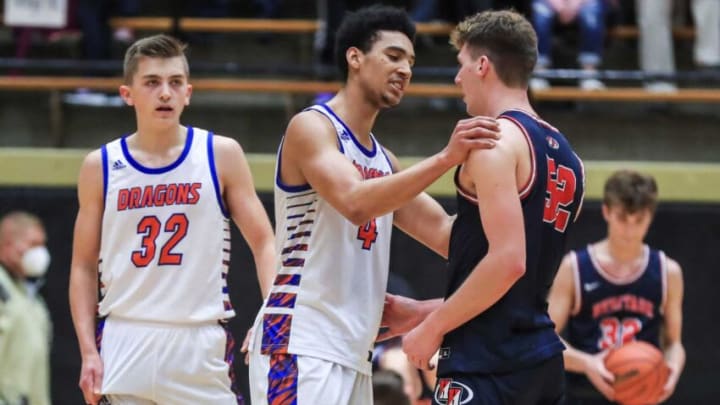 Silver Creek's Trey Kaufmann-Renn consoles Heritage Hills Blake Sisley after the Dragons advanced 52-48 in the 3A Boys Regional semifinal at the Hatchet House in Washington, Ind. Saturday morning.Silver Creek Vs Heritage Hills 3a Boys Regional