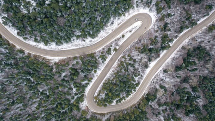 BURSA, TURKIYE - NOVEMBER 29: An aerial view of a road at Uludag, an important center of winter tourism as fog and snow blanket over the trees and the mountain in Bursa, Turkiye on November 29, 2022. (Photo by Sergen Sezgin/Anadolu Agency via Getty Images)
