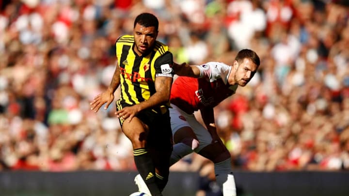LONDON, ENGLAND - SEPTEMBER 29: Troy Deeney of Watford takes the ball away from Aaron Ramsey (R) of Arsenal during the Premier League match between Arsenal FC and Watford FC at Emirates Stadium on September 29, 2018 in London, United Kingdom. (Photo by Julian Finney/Getty Images)