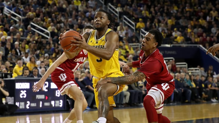 ANN ARBOR, MICHIGAN – JANUARY 06: Zavier Simpson #3 of the Michigan Wolverines drives between Devonte Green #11 and Zach McRoberts #15 of the Indiana Hoosiers during the first half at Crisler Arena on January 06, 2019 in Ann Arbor, Michigan. (Photo by Gregory Shamus/Getty Images)