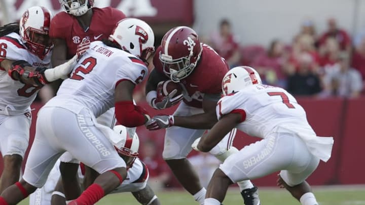 Sep 10, 2016; Tuscaloosa, AL, USA; Alabama Crimson Tide running back Damien Harris (34) is hit by Western Kentucky Hilltoppers defensive back Joe Brown (7) and linebacker Keith Brown (2) at Bryant-Denny Stadium. The Tide defeated the Hilltoppers 38-10. Mandatory Credit: Marvin Gentry-USA TODAY Sports