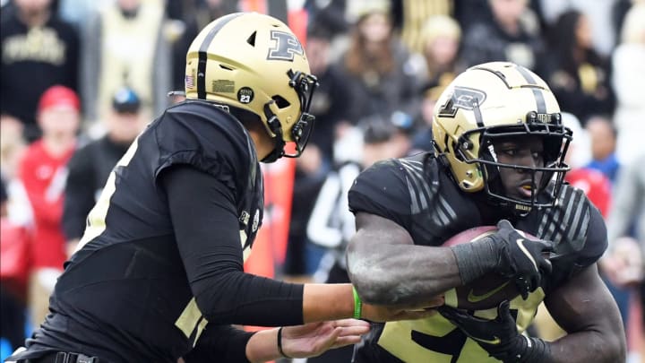 Oct 23, 2021; West Lafayette, Indiana, USA; Purdue Boilermakers quarterback Aidan O’Connell (16) hands the ball off to Purdue Boilermakers running back King Doerue (22) during the game at Ross-Ade Stadium. Mandatory Credit: Robert Goddin-USA TODAY Sports