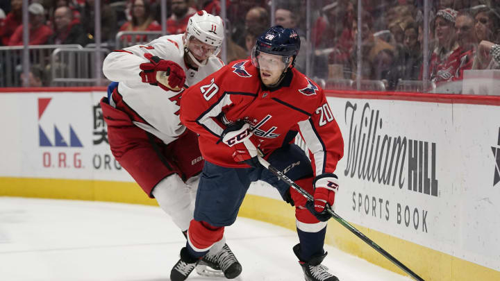 WASHINGTON, DC – JANUARY 13: Lars Eller #20 of the Washington Capitals skates with the puck against Jordan Staal #11 of the Carolina Hurricanes in the first period at Capital One Arena on January 13, 2020 in Washington, DC. (Photo by Patrick McDermott/NHLI via Getty Images)