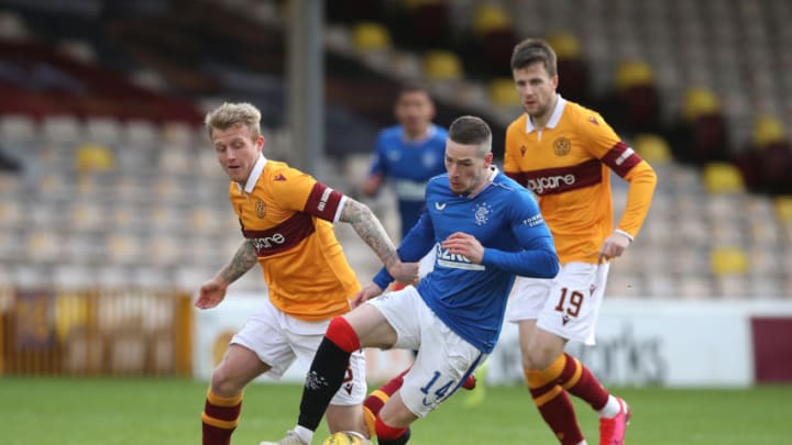 MOTHERWELL, SCOTLAND - JANUARY 17: Ryan Kent of Rangers is challenged by Robbie Crawford of Motherwell during the Ladbrokes Scottish Premiership match between Motherwell and Rangers at Fir Park on January 17, 2021 in Motherwell, Scotland. Sporting stadiums around Scotland remain under strict restrictions due to the Coronavirus Pandemic as Government social distancing laws prohibit fans inside venues resulting in games being played behind closed doors. (Photo by Ian MacNicol/Getty Images)