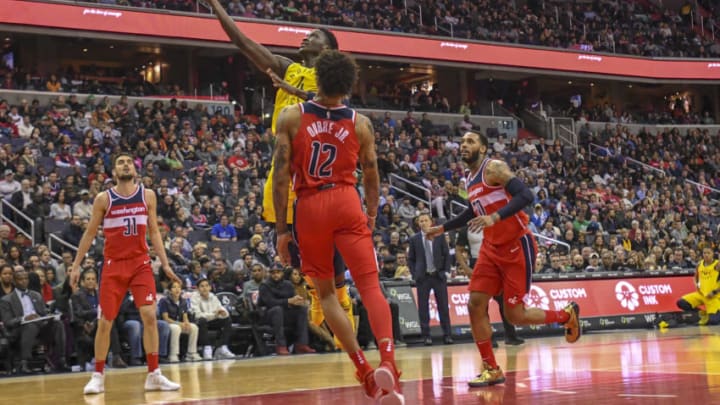 WASHINGTON, DC - MARCH 17: Indiana Pacers guard Victor Oladipo (4) scores against Washington Wizards forward Kelly Oubre Jr. (12) on March 17, 2018 at the Capital One Arena in Washington, D.C. The Washington Wizards defeated the Indiana Pacers, 109-102. (Photo by Icon Sportswire)