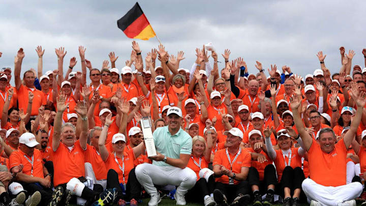 COLOGNE, GERMANY - JUNE 24: Matt Wallace of England celebrates with the trophy and tournament volunteers after winning the BMW International Open at Golf Club Gut Larchenhof on June 24, 2018 in Cologne, Germany. (Photo by Matthew Lewis/Getty Images)