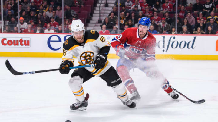 MONTREAL, QC - DECEMBER 17: Boston Bruins right wing David Pastrnak (88) and Montreal Canadiens defenseman Mike Reilly (28) battle for the puck during the third period of the NHL game between the Boston Bruins and the Montreal Canadiens on December 17, 2018, at the Bell Centre in Montreal, QC (Photo by Vincent Ethier/Icon Sportswire via Getty Images)