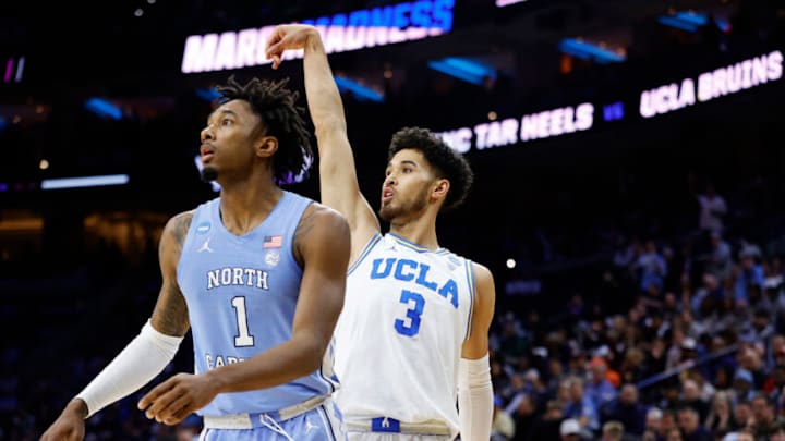 PHILADELPHIA, PENNSYLVANIA - MARCH 25: Johnny Juzang #3 of the UCLA Bruins and Leaky Black #1 of the North Carolina Tar Heels watch Juzang's shot in the first half of the game in the Sweet Sixteen round of the 2022 NCAA Men's Basketball Tournament at Wells Fargo Center on March 25, 2022 in Philadelphia, Pennsylvania. (Photo by Tim Nwachukwu/Getty Images)