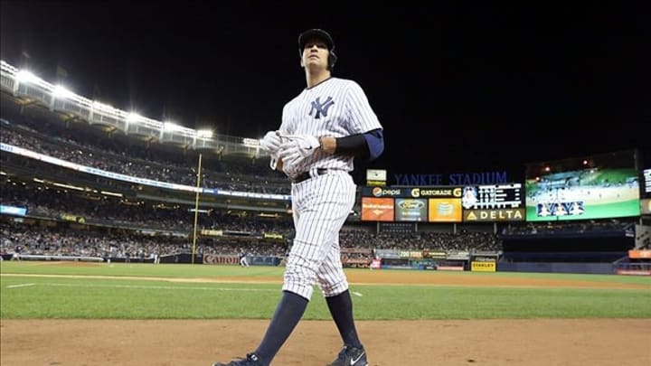 Sep 24, 2013; Bronx, NY, USA; New York Yankees third baseman Alex Rodriguez walks back to the dugout after flying out to end the fourth inning against the Tampa Bay Rays at Yankee Stadium. Mandatory Credit: John Munson/THE STAR-LEDGER via USA TODAY Sports