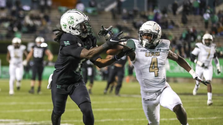 Nov 13, 2021; Huntington, West Virginia, USA; UAB Blazers cornerback Starling Thomas V (4) breaks up a pass intended for Marshall Thundering Herd wide receiver Willie Johnson (1) during the fourth quarter at Joan C. Edwards Stadium. Mandatory Credit: Ben Queen-USA TODAY Sports