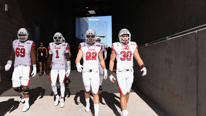 TEMPE, AZ – NOVEMBER 03: (L-R) Offensive lineman Lo Falemaka #69, quarterback Tyler Huntley #1, linebacker Chase Hansen #22 and linebacker Cody Barton #30 of the Utah Utes walk out onto the field before the college football game against the Arizona State Sun Devils at Sun Devil Stadium on November 3, 2018 in Tempe, Arizona. The Sun Devils defeated the 38-20. (Photo by Christian Petersen/Getty Images)
