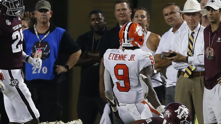 COLLEGE STATION, TX – SEPTEMBER 08: Travis Etienne #9 of the Clemson Tigers scores on a 1 yard run in the third quarter as he beats Donovan Wilson #6 of the Texas A&M Aggies to the endzone at Kyle Field on September 8, 2018 in College Station, Texas. (Photo by Bob Levey/Getty Images)