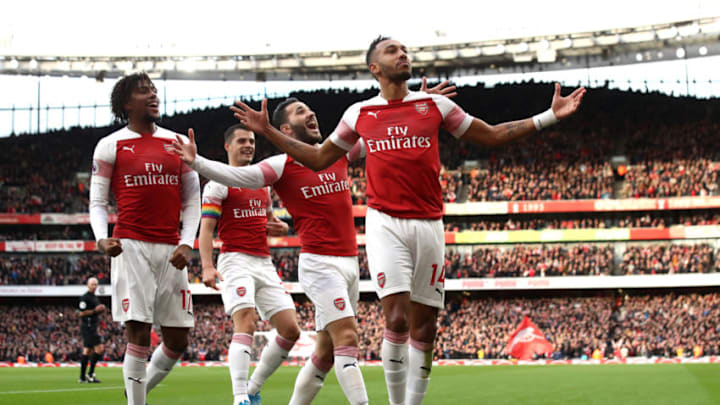 LONDON, ENGLAND - DECEMBER 02: Pierre-Emerick Aubameyang of Arsenal celebrates with teammates after scoring his team's first goal during the Premier League match between Arsenal FC and Tottenham Hotspur at Emirates Stadium on December 1, 2018 in London, United Kingdom. (Photo by Julian Finney/Getty Images)