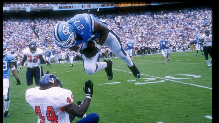 27 Sep 1997: Jonathan Linton #27 of North Carolina flies in the air as Wali Rainer #44 of the Virginia Cavaliers falls to the ground during the Tar Heels 48-20 win at Kenan Stadium in Chapel Hill, North Carolina. Mandatory Credit: Doug Pensinger /Allsport