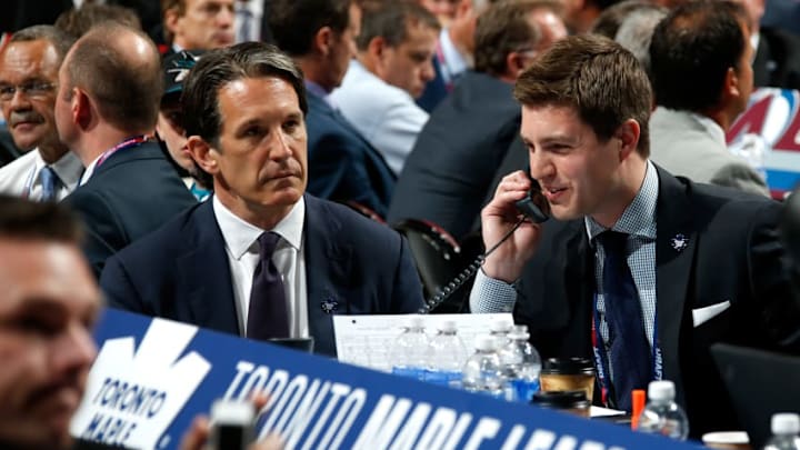 SUNRISE, FL - JUNE 26: Kyle Dubas Assistant General Manager of the Toronto Maple Leafs talks on the phone as President Brendan Shanahan looks on during the first round of the 2015 NHL Draft at BB