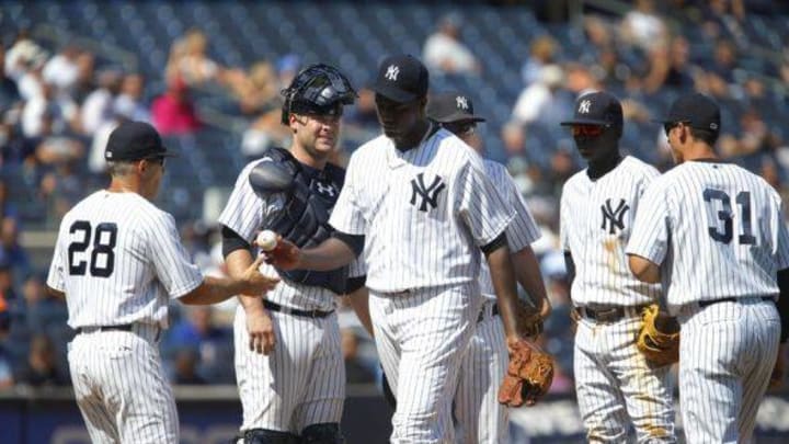 Aug 26, 2015; Bronx, NY, USA; New York Yankees manager Joe Girardi (28) takes the ball from starting pitcher Michael Pineda (35) in the fifth inning against the Houston Astros at Yankee Stadium. Mandatory Credit: Noah K. Murray-USA TODAY Sports