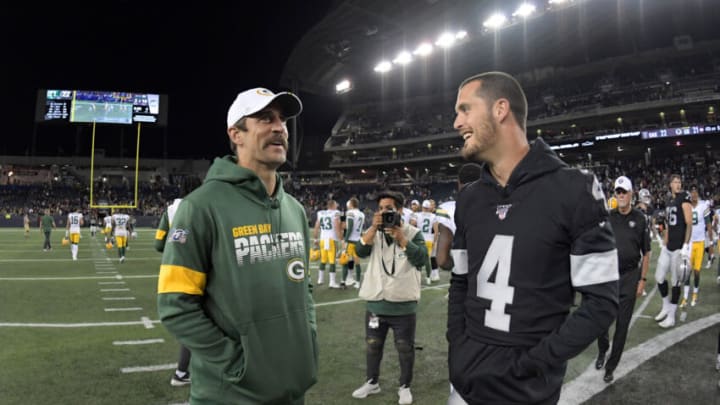 Aug 22, 2019; Winnipeg, Manitoba, CAN; Green Bay Packers quarterback Aaron Rodgers (left) talks with Oakland Raiders quarterback Derek Carr (4) after a game at Investors Group Field. The Raiders defeated the Packers 22-21. Mandatory Credit: Kirby Lee-USA TODAY Sports