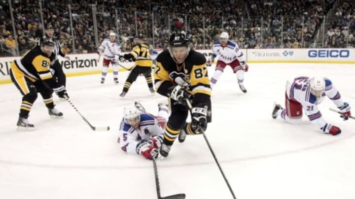 Mar 3, 2016; Pittsburgh, PA, USA; New York Rangers defenseman Dan Girardi (5) reaches for the puck against Pittsburgh Penguins center Sidney Crosby (87) during the second period at the CONSOL Energy Center. Mandatory Credit: Charles LeClaire-USA TODAY Sports