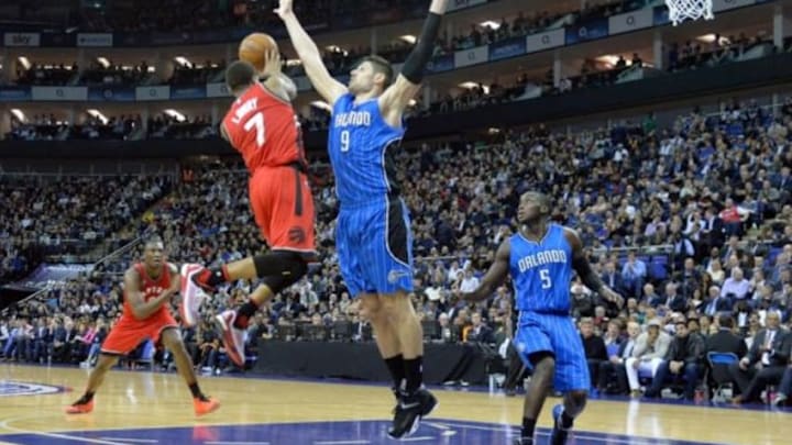 Jan 14, 2016; London, United Kingdom; Toronto Raptors guard Kyle Lowry (7) passes against Orlando Magic center Nikola Vucevic (9) during the NBA Global Games at The O2 Arena. Raptors won the games 106-103 in overtime. Mandatory Credit: Leo Mason-USA TODAY Sports