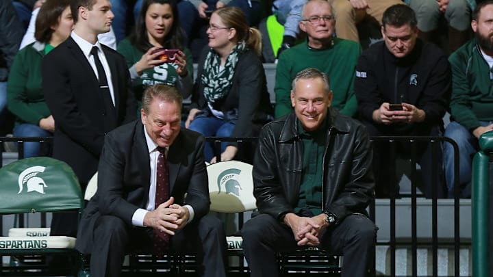 EAST LANSING, MI – JANUARY 02: Head coach Tom Izzo of the Michigan State Spartans (L) shares a laugh with Michigan State football head coach Mark Dantonio before tonight’s game against the Northwestern Wildcats at Breslin Center on January 2, 2019 in East Lansing, Michigan. (Photo by Rey Del Rio/Getty Images)