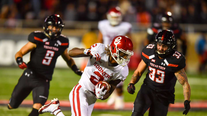 CeeDee Lamb #2 of the Oklahoma Sooners gains yardage after making the catch during the second half of the game against the Texas Tech Red Raiders  (Photo by John Weast/Getty Images)