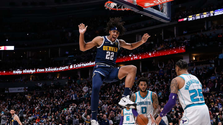 Denver Nuggets forward Zeke Nnaji (22) reacts after dunking the ball against Charlotte Hornets forward Miles Bridges (0) and forward P.J. Washington (25) in the first quarter at Ball Arena on 23 Dec. 2021. (Isaiah J. Downing-USA TODAY Sports)