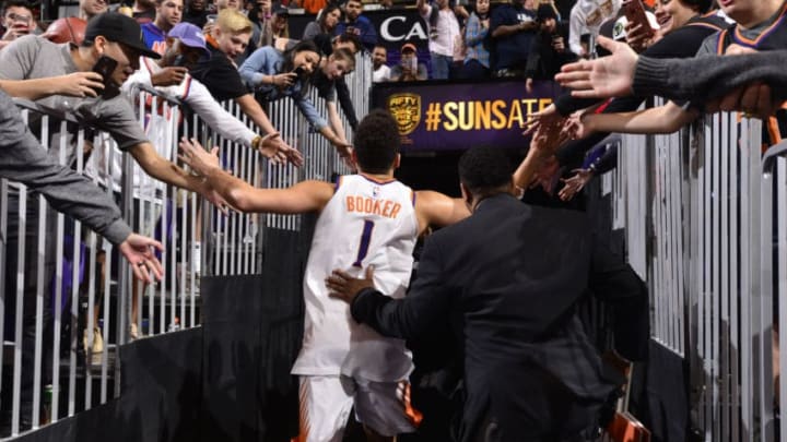 PHOENIX, AZ - JANUARY 7: Devin Booker #1 of the Phoenix Suns high fives fans after the game against the Oklahoma City Thunder on January 7, 2018 at Talking Stick Resort Arena in Phoenix, Arizona. NOTE TO USER: User expressly acknowledges and agrees that, by downloading and or using this photograph, user is consenting to the terms and conditions of the Getty Images License Agreement. Mandatory Copyright Notice: Copyright 2018 NBAE (Photo by Barry Gossage/NBAE via Getty Images)
