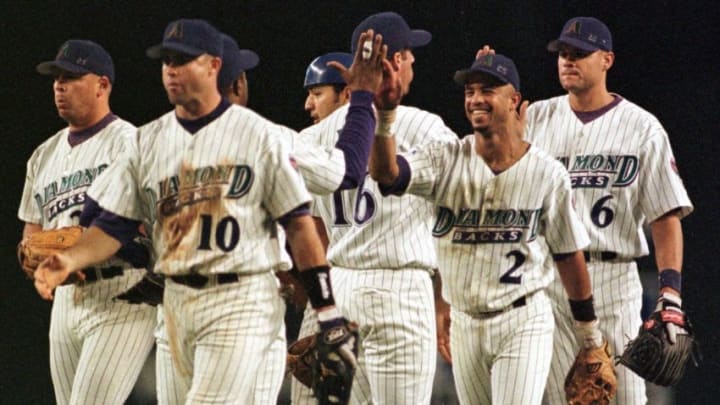 PHOENIX, AZ - OCTOBER 3: Arizona Diamondbacks Turner Ward (10), Hanley Frias (2) and Andy Fox (6) celebrate with their teammates following their win over the San Diego Padres 03 October, 1999, in Phoenix, AZ. The Diamondbacks won 10-3 to finish the season with 100 wins. (Photo credit should read MIKE FIALA/AFP via Getty Images)