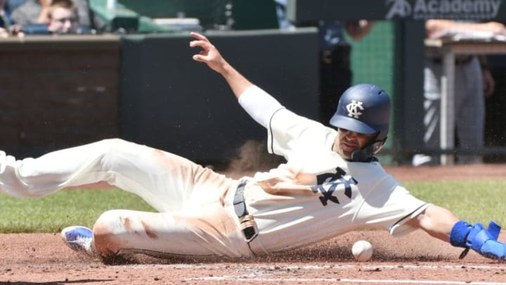 KANSAS CITY, MO - MAY 6: Whit Merrifield #15 of the Kansas City Royals slides across home to score on a Mike Moustakas sacrifice fly in the first inning against the Detroit Tigers at Kauffman Stadium on May 6, 2018 in Kansas City, Missouri. (Photo by Ed Zurga/Getty Images)