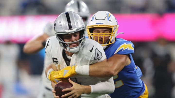 INGLEWOOD, CALIFORNIA - OCTOBER 04: Quarterback Derek Carr #4 of the Las Vegas Raiders is tackled by linebacker Kyler Fackrell #52 of the Los Angeles Chargers during the second half at SoFi Stadium on October 4, 2021 in Inglewood, California. (Photo by Sean M. Haffey/Getty Images)