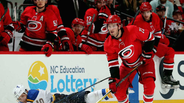 RALEIGH, NC - OCTOBER 27: Brett Pesce #22 of the Carolina Hurricanes collects the puck as Brayden Schenn #10 of the St. Louis Blues falls to the ice during an NHL game on October 27, 2017 at PNC Arena in Raleigh, North Carolina. (Photo by Gregg Forwerck/NHLI via Getty Images)