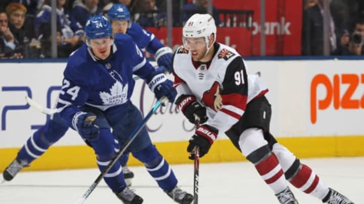 TORONTO, ON – FEBRUARY 11: Taylor Hall #91 of the Arizona Coyotes skates with the puck against Kasperi Kapanen #24 of the Toronto Maple Leafs during an NHL game at Scotiabank Arena on February 11, 2020, in Toronto, Ontario, Canada. The Maple Leafs defeated the Coyotes 3-2 in overtime. (Photo by Claus Andersen/Getty Images)