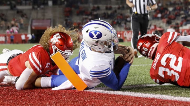 HOUSTON, TEXAS - OCTOBER 16: Zach Wilson #1 of the BYU Cougars is tackled near the goal line by Grant Stuard #0 of the Houston Cougars and Gervarrius Owens #32 in the first half at TDECU Stadium on October 16, 2020 in Houston, Texas. (Photo by Tim Warner/Getty Images)