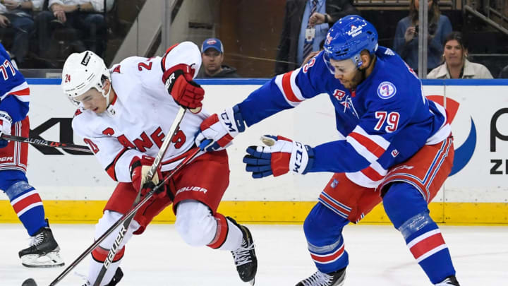 Apr 12, 2022; New York, New York, USA; Carolina Hurricanes center Seth Jarvis (24) skates with the puck defended by New York Rangers defenseman K’Andre Miller (79) during the second period at Madison Square Garden. Mandatory Credit: Dennis Schneidler-USA TODAY Sports