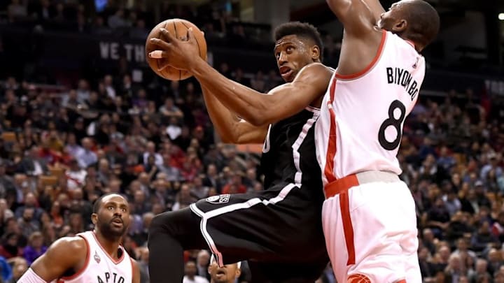 Mar 8, 2016; Toronto, Ontario, CAN; Brooklyn Nets forward Thaddeus Young (30) tries to shoot for a basket as Toronto Raptors center Bismack Biyombo (8) defends in the second half of the Raptors 104-99 win at Air Canada Centre. Mandatory Credit: Dan Hamilton-USA TODAY Sports