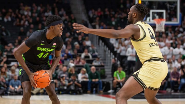 Michigan State forward Gabe Brown (44) looks for an opening around Oakland forward Daniel Oladapo (4) during the game against Oakland at Little Caesars Arena in Detroit, Saturday, Dec. 14, 2019. Michigan State won, 72-49.121419 Msuvou Amb 6