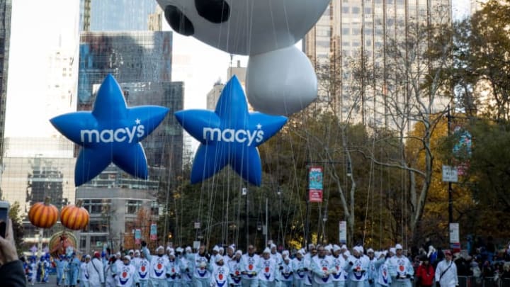 Balloon handlers float Olaf down Central Park South during the annual Macy's Thanksgiving Day Parade.