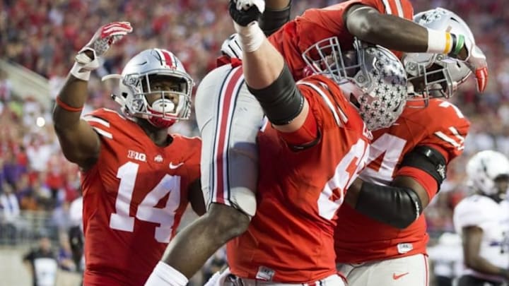 Oct 29, 2016; Columbus, OH, USA; Ohio State Buckeyes running back Curtis Samuel (4) celebrates with offensive linemen Pat Elflein (65) and Jamarco Jones (74) and wide receiver K.J. Hill (14) after scoring the final touchdown in the fourth quarter against the Northwestern Wildcats at Ohio Stadium. Ohio State won 24-20. Mandatory Credit: Greg Bartram-USA TODAY Sports